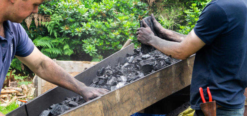 Two men on a charcoal making course