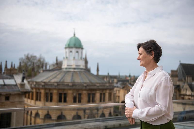 Professor Irene Tracey stands outdoors, looking to her right. 