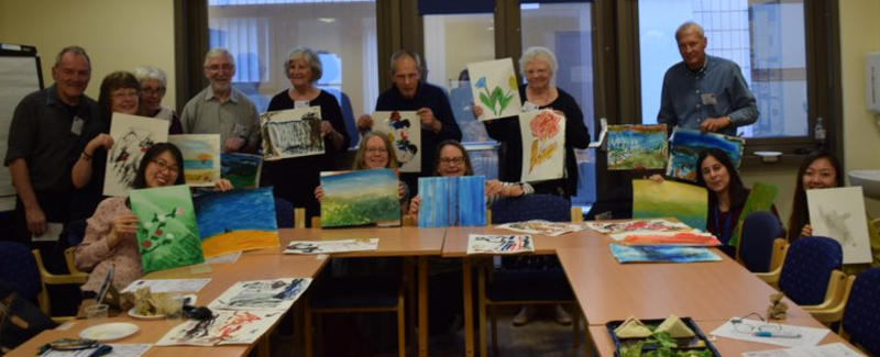 Participants in the Picturing Parkinson's project, with pieces of their artwork