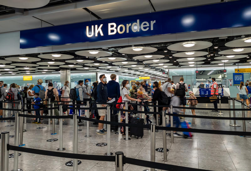 Arriving internation travel passengers waiting for immigration control and passport check at airport