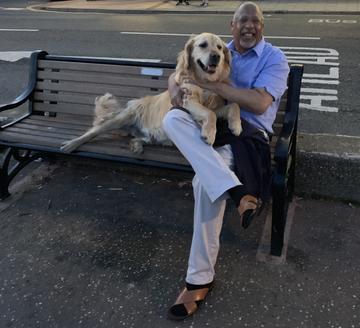 Dr David Johnson seated with Woody his golden retriever