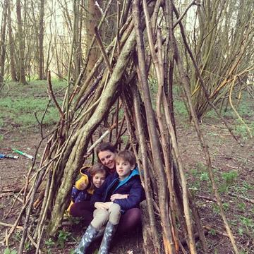 Family in a den in the woods