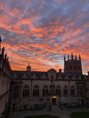 A vibrant pink sunset behind Oriel college's first quad