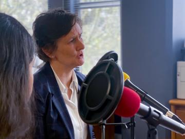 The Vice-Chancellor speaking into a microphone while recording the first episode of her podcast