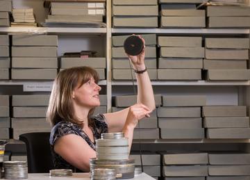 Susan Thomas viewing museum archives by John Cairns