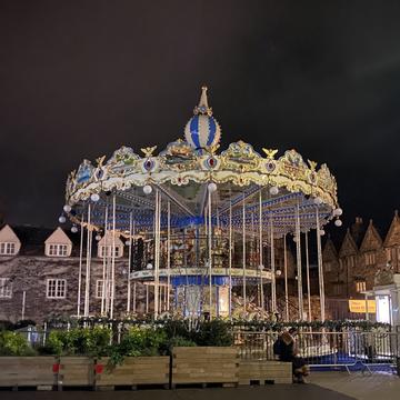 A photo taken at night of a carousel