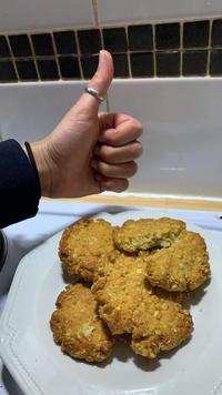 A plate of homemade anzac cookies with a thumbs up